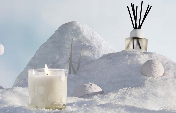 pine & eucalyptus home candle & diffuser, amongst snowballs and on a bed of snow. 